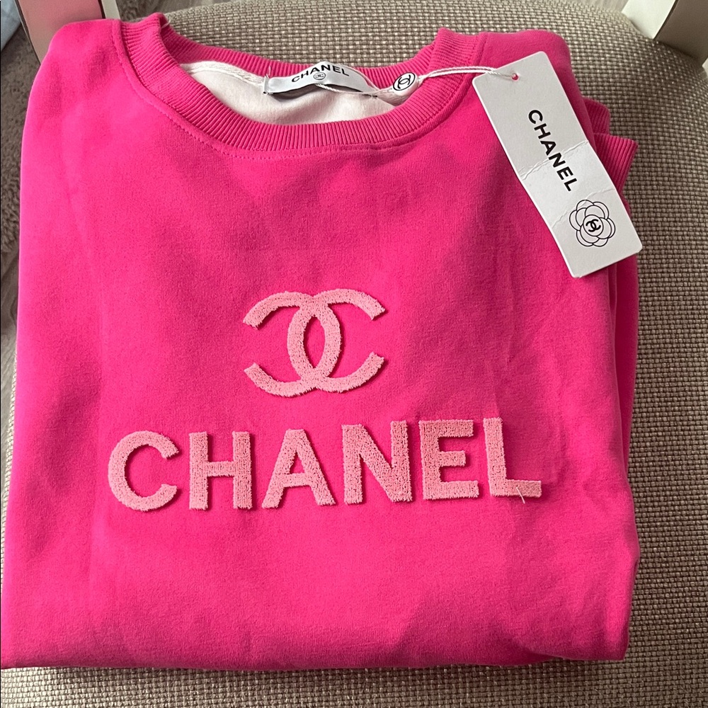 Pink lined sweatshirt , with raised letters on shirt. This sweatshirt is soft